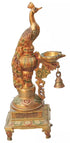 Hand-painted brass peacock on a square plinth holding an oil dish, with a hanging bell