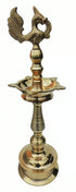 Brass oil lamp crowned with a cast peacock, ribbed stem and heavy round base