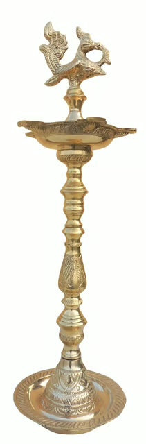 Tall standing brass kuthuvilakku oil lamp with annam finial and broad weighted base