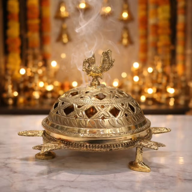 Wide brass loban dan with pierced dome lid and a broad ash tray on cast feet