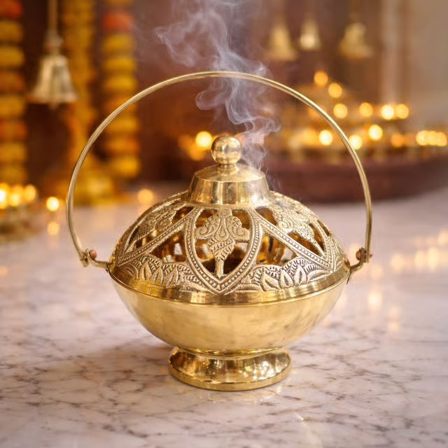 Deep brass bowl with an arched carrying bow and a pierced chased lid