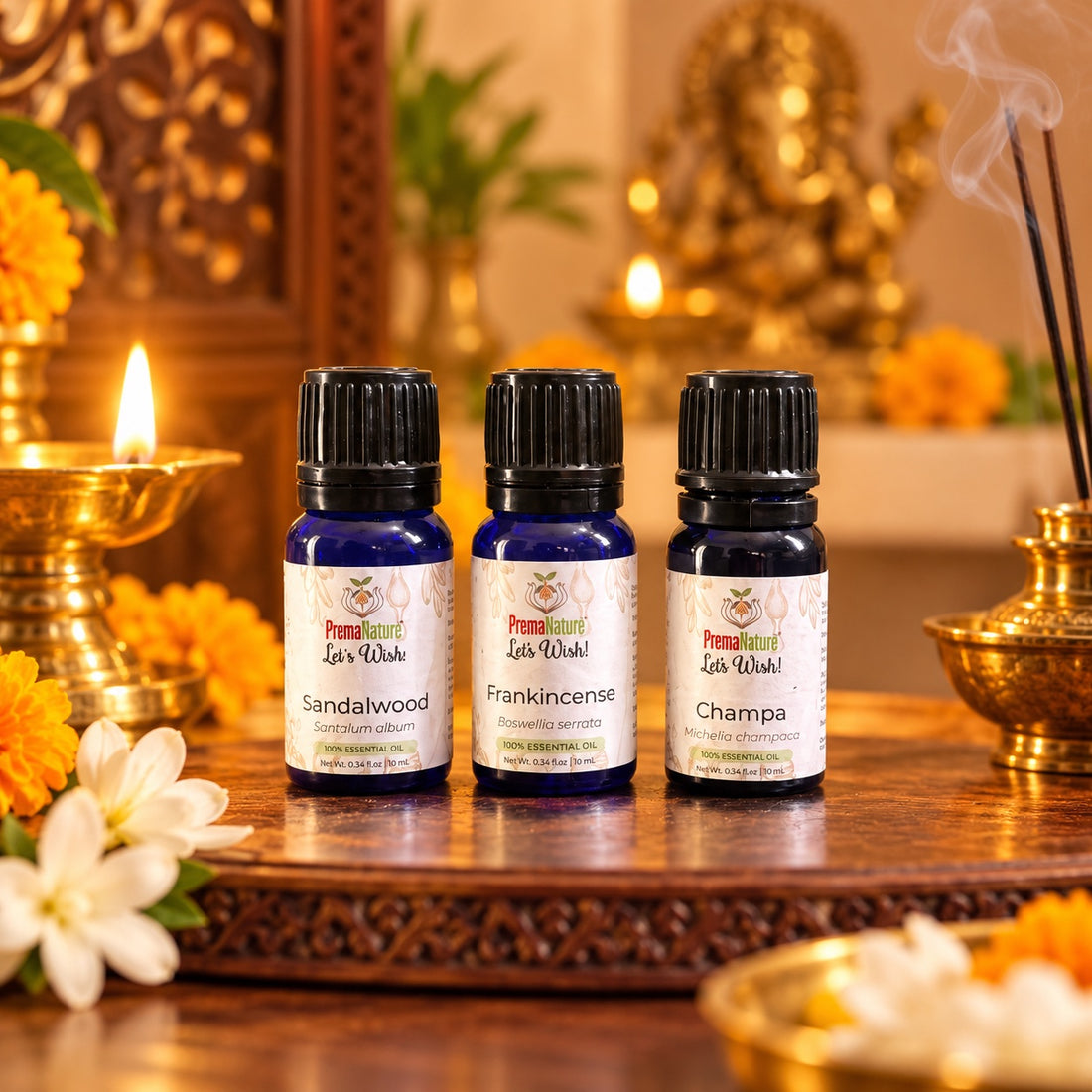 PremaNature Pooja &amp; Meditation Oil Set: Sandalwood, Frankincense and Champa essential oils on a pooja altar with a brass diya