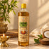 PremaNature Pancha Deepam Oil 1 litre, cold-pressed pooja lamp oil of sesame, coconut, mahua, castor and cow ghee, beside a lit brass diya