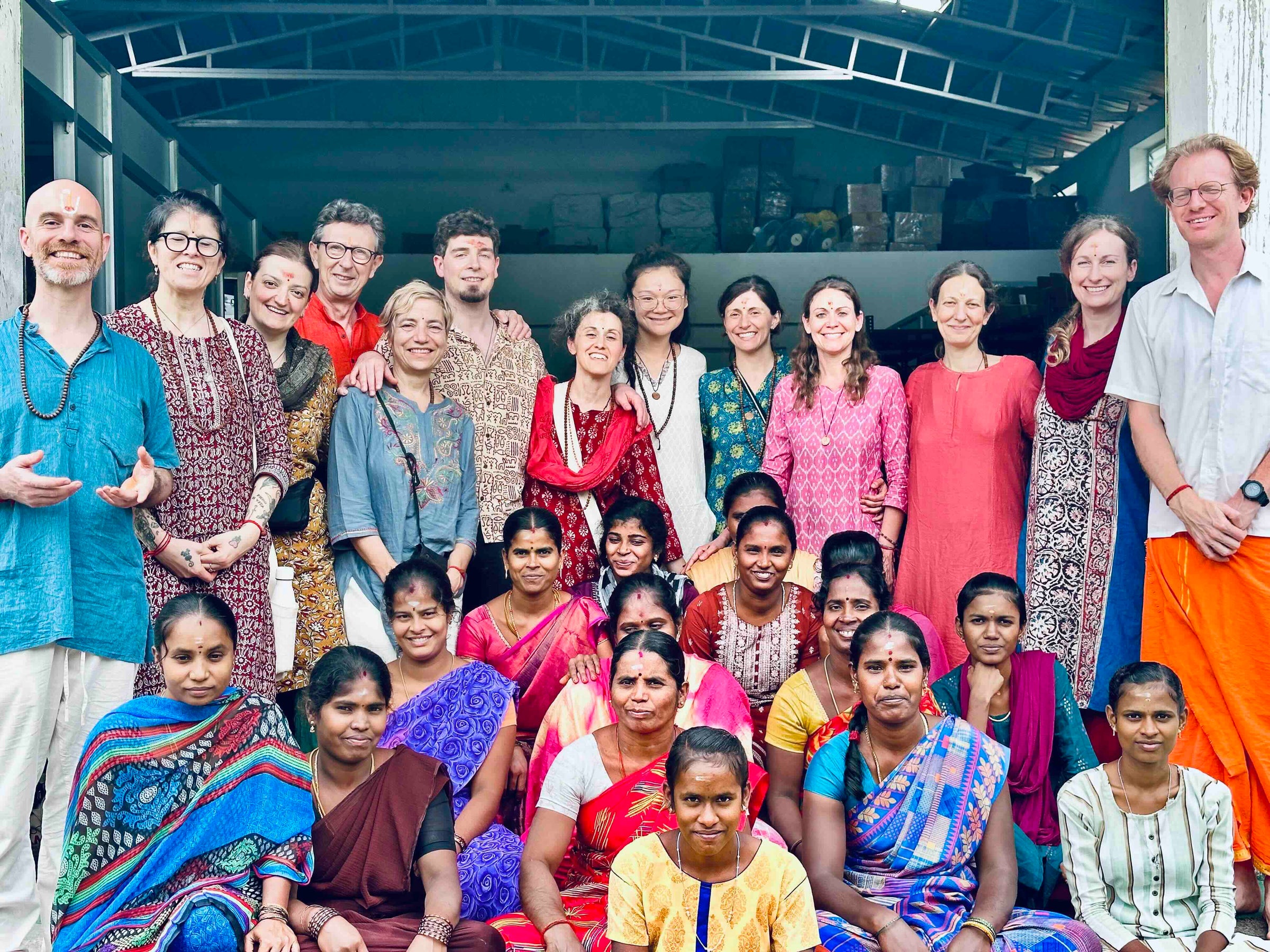 The PremaNature workshop team photographed together with visiting guests outside the production unit